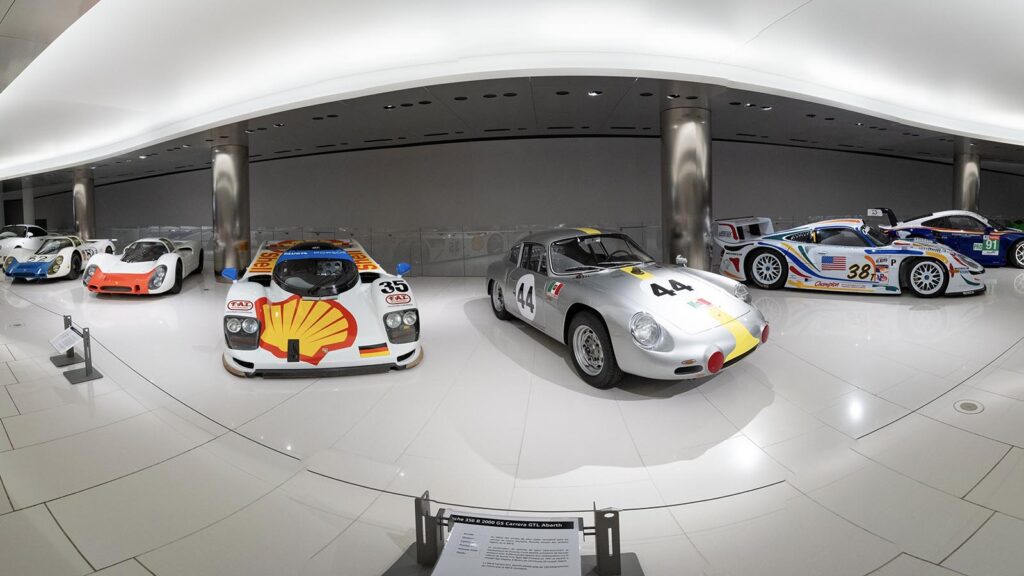 Row of Porsche 911s next to one another showroom
