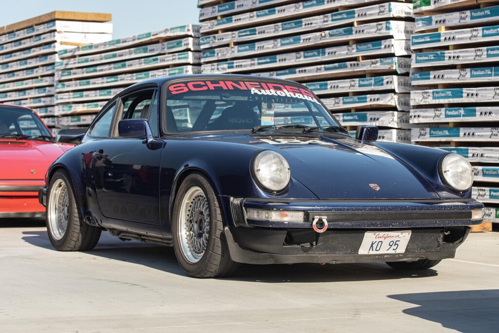 dark blue Porsche 911 SC on road