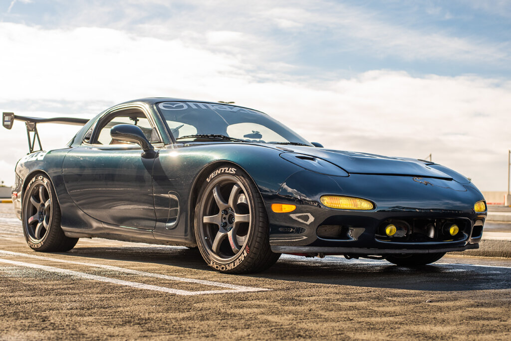 blue Mazda RX7 in parking lot