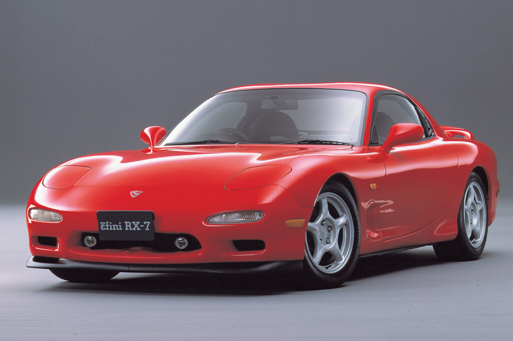red Mazda RX7 FD parked with grey background