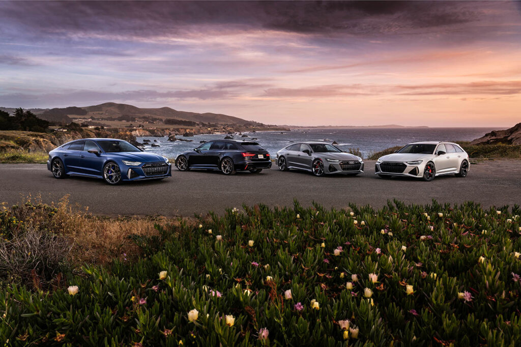 group of audi r6 avant and r7 performance models at a beach