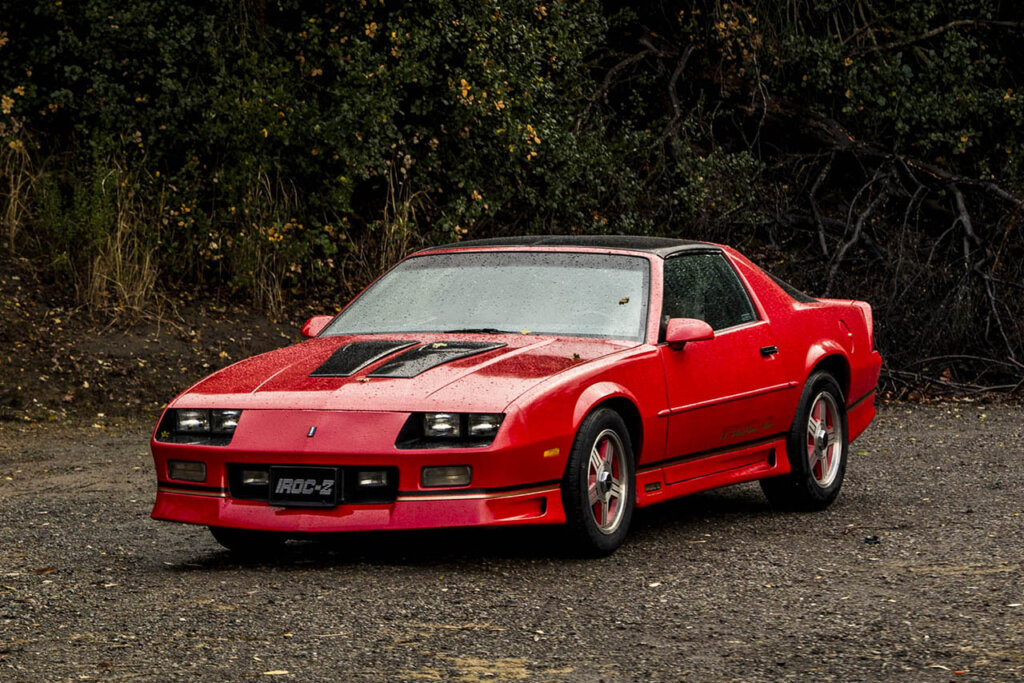red third gen camaro in forest