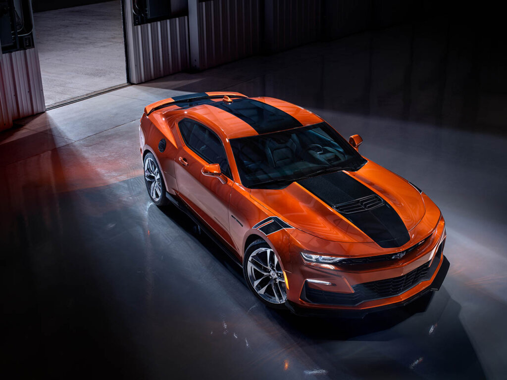 Orange 2023 Chevrolet Camaro SS parked in hangar