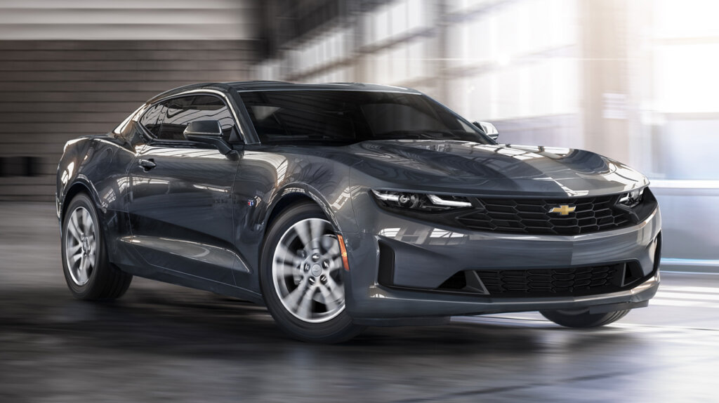 Gray base 2023 chevrolet camaro driving inside a warehouse