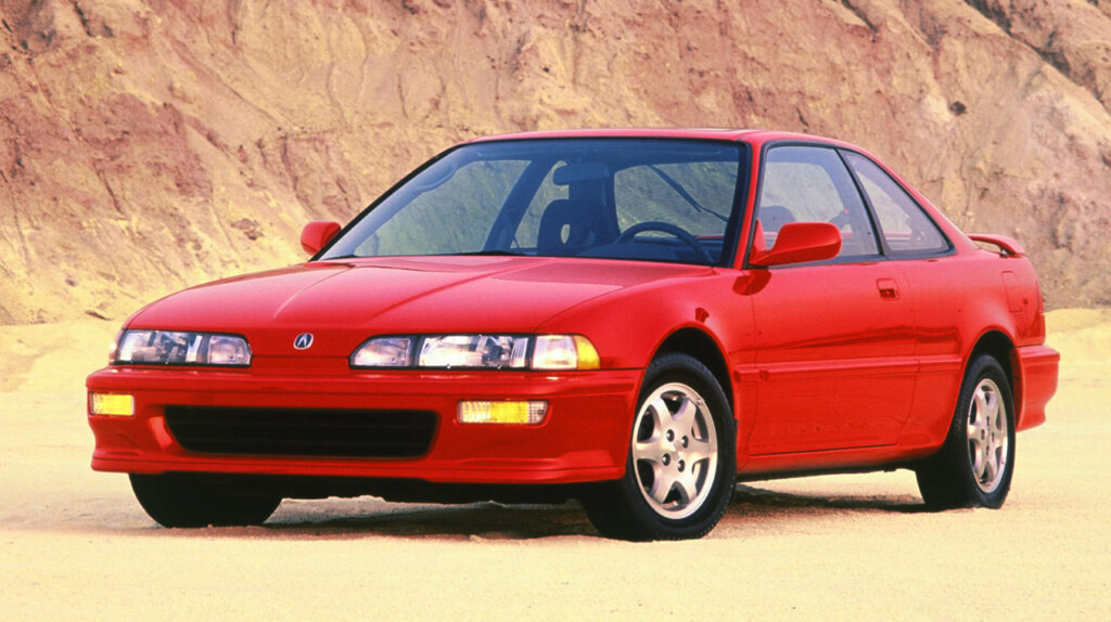 red 1993 Acura Integra at a beach