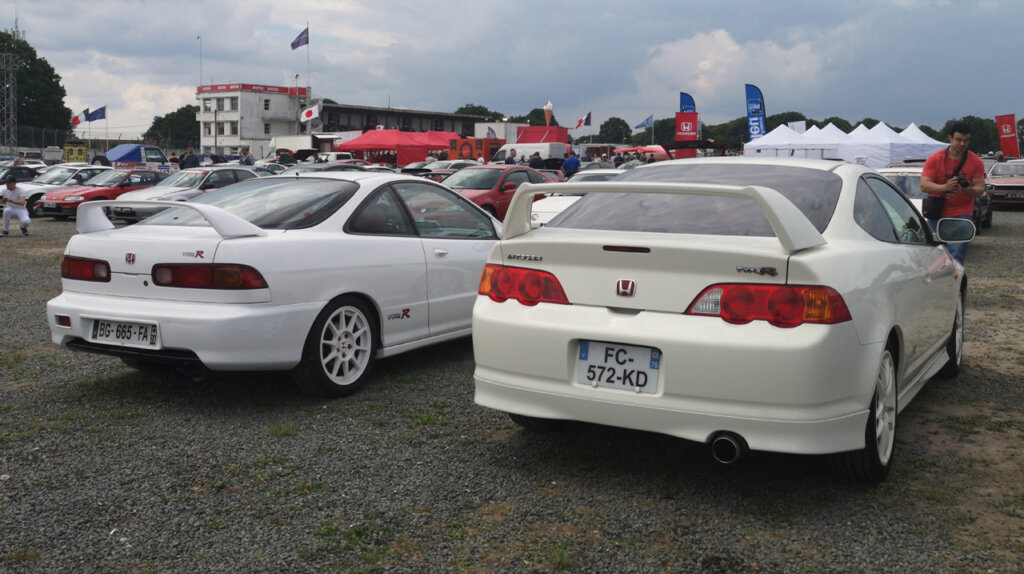 Rear view of a white third generation Honda Integra Type-R and a fourth generation Honda Integra Type-R at a car show