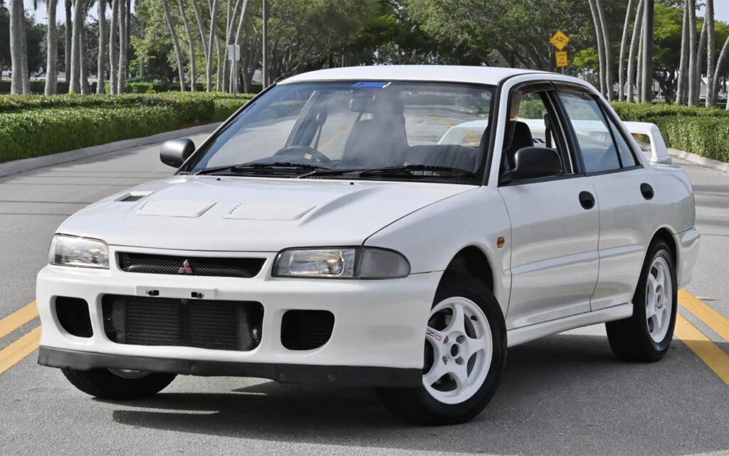 white mitsubishi lancer at a resort
