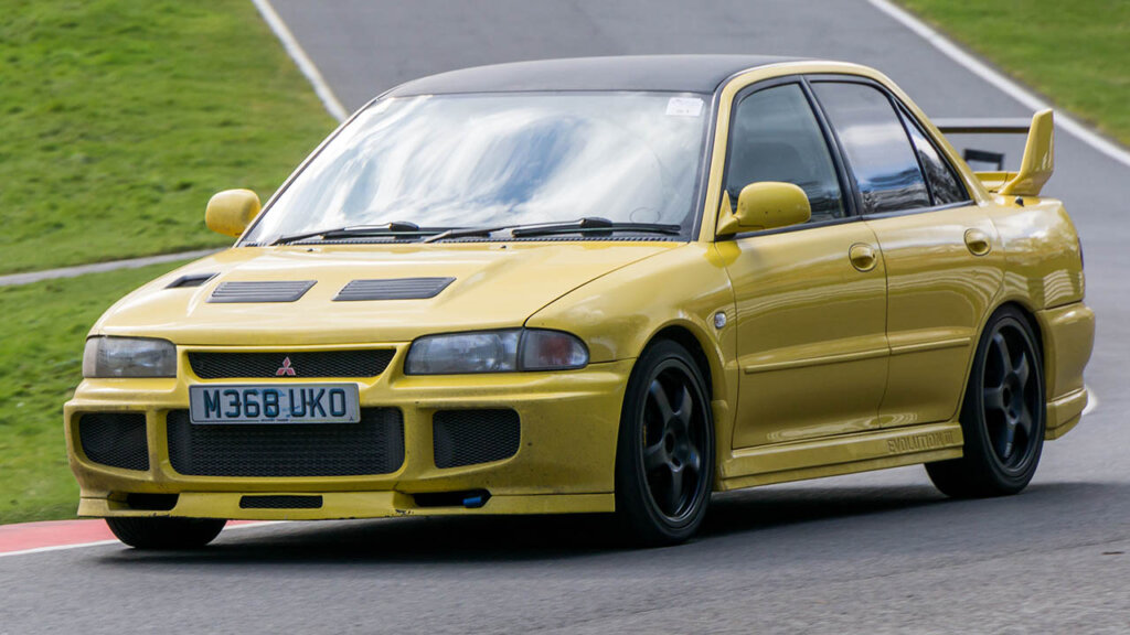 yellow lancer EVO III on a racetrack