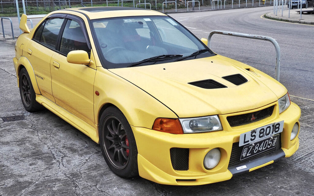 yellow lancer evo V in parking lot