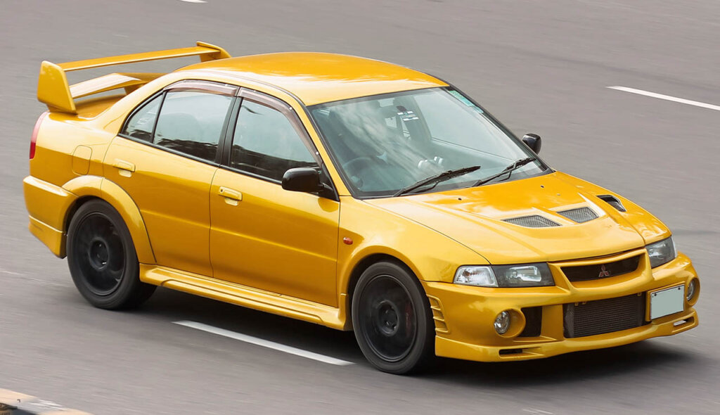yellow lancer evo VI on highway