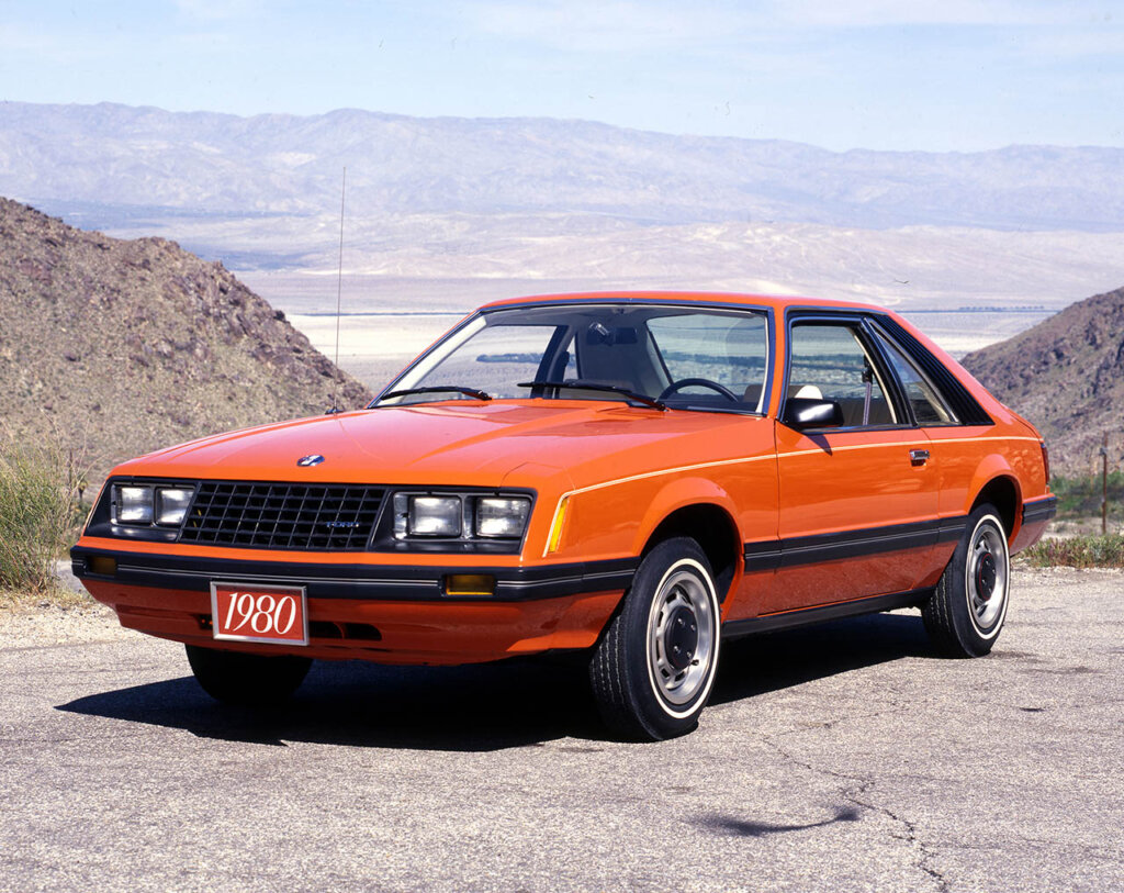 orange third gen mustang at a desert
