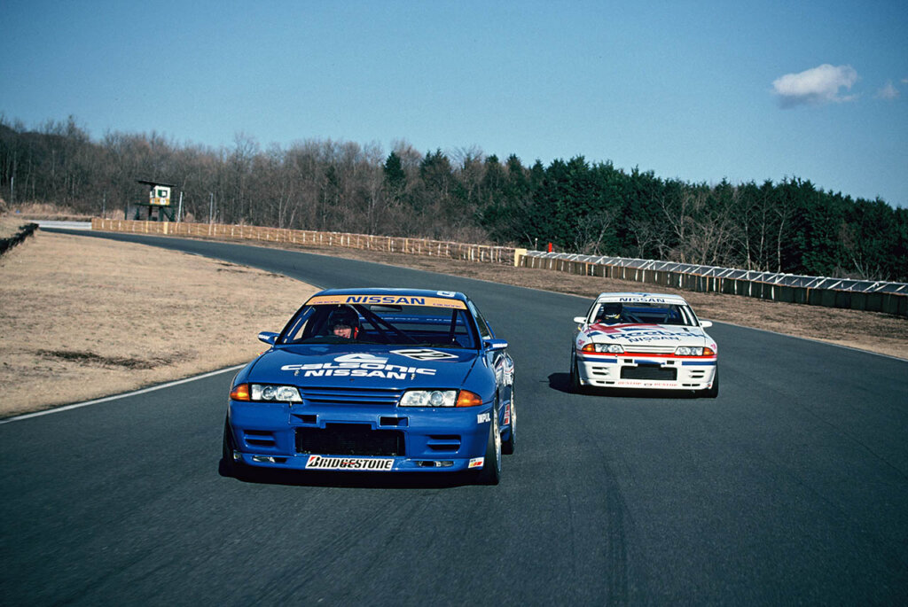 blue and white nissan r-32 skyline on a racetrack