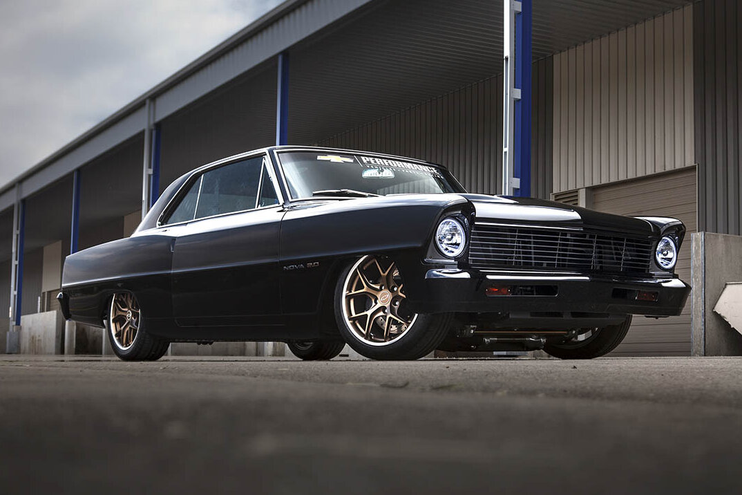 black 1967 Chevy Nova 2.0 next to a docking bay