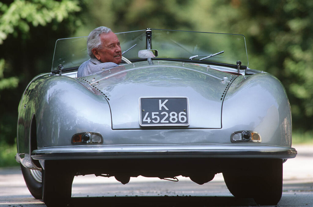 man driving silver porshce 356A