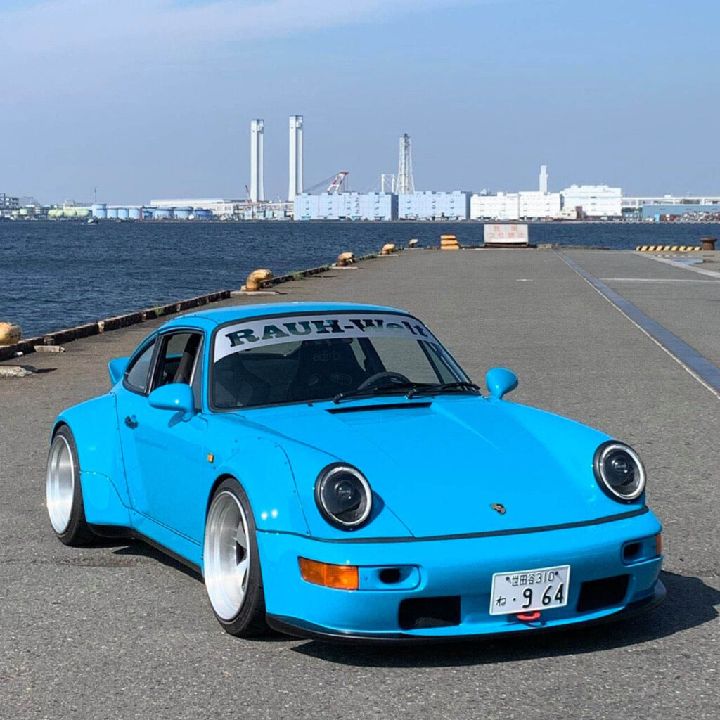 sky blue porsche 964 on a dock