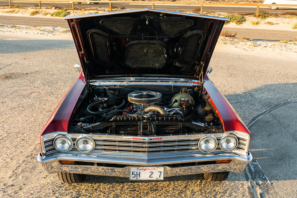 engine bay of a red chevelle malibu