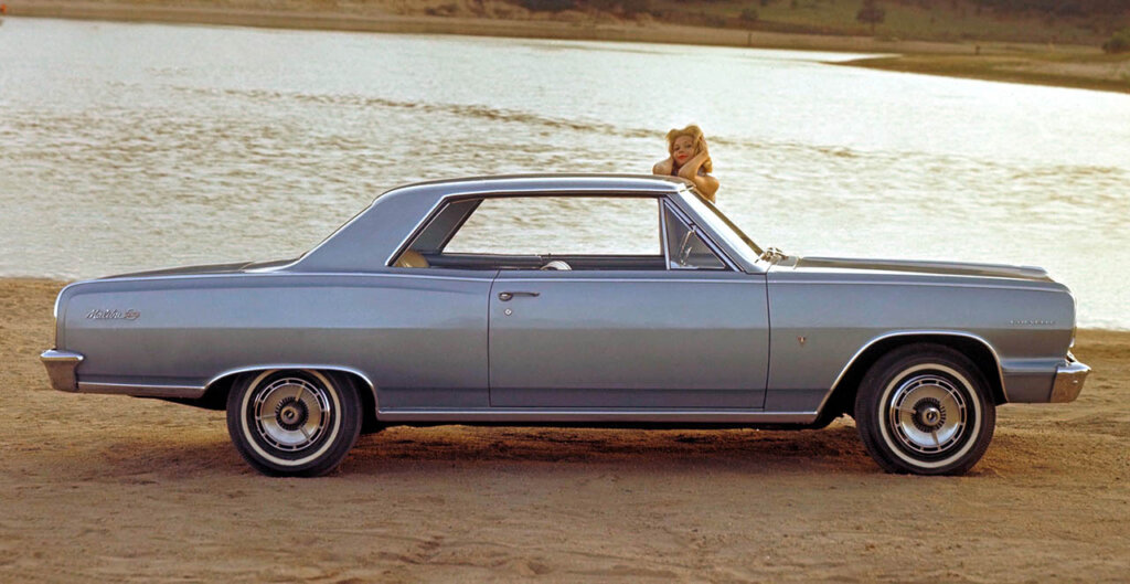 woman standing next to 1964 Chevrolet Chevelle Malibu SS