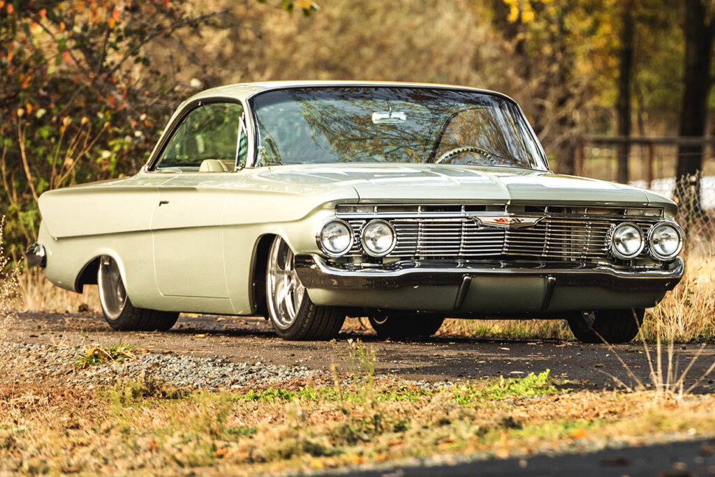 green 1961 third gen impala in a park