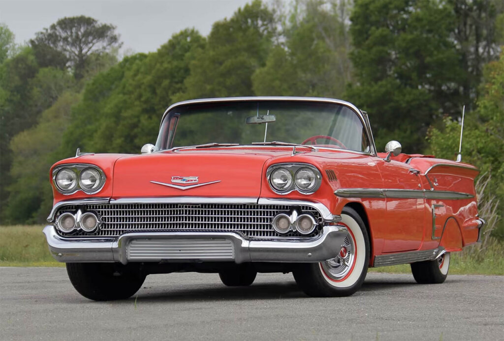 red orange 1958 Chevrolet impala convertible on runway