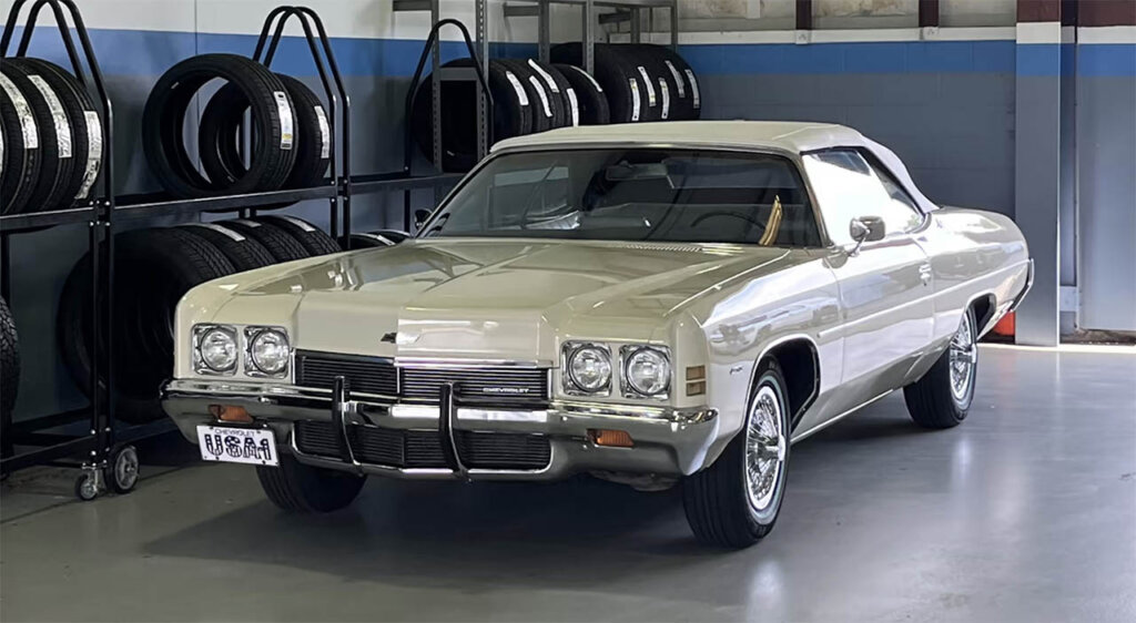 cream 1972 chevy impala convertible in a garage