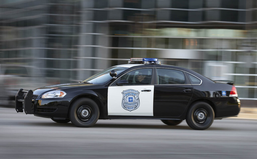 2011 Chevrolet Impala Police Vehicle driving through city