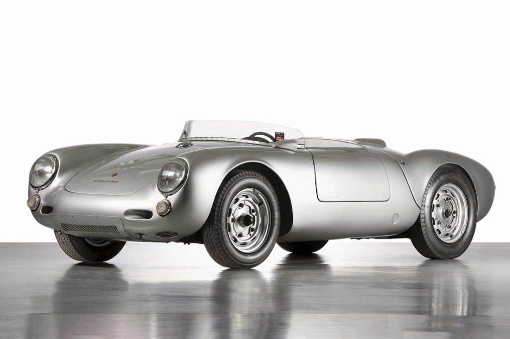 Silver Porsche 550 Spyder on concrete with white background