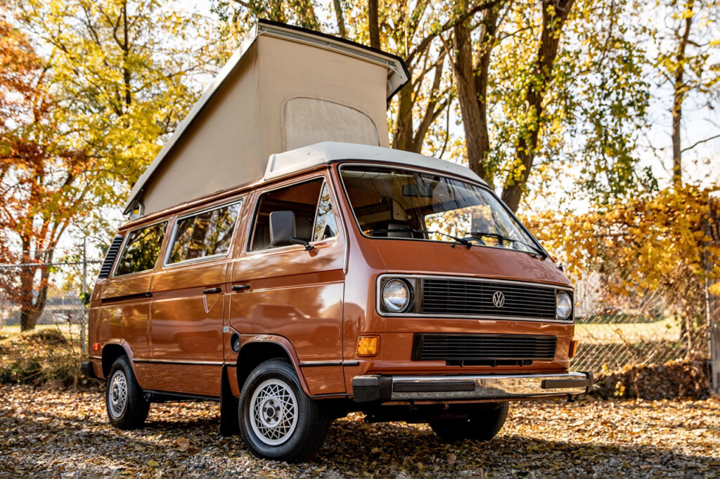 Front quarter shot of Vanawagon with top up infront of trees