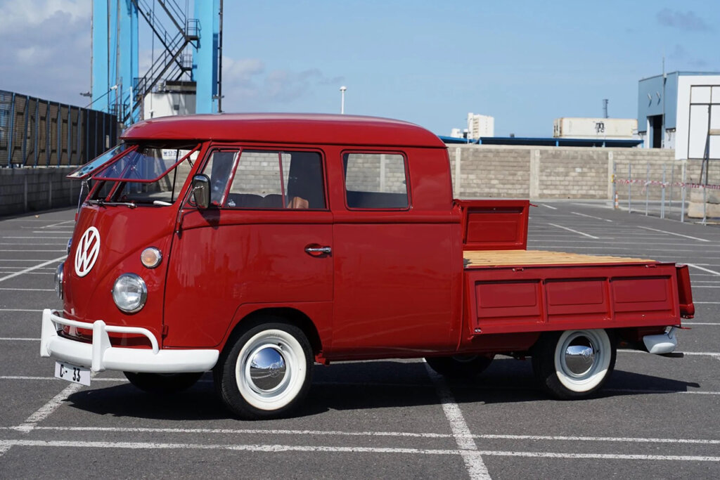 red transporter VW bus in shipping docks
