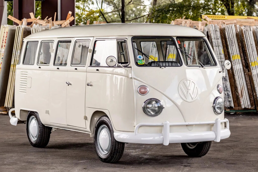 White VW bus in front of shipping material
