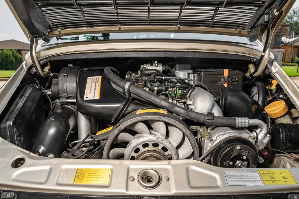 flat six in a silver car hoses and fans fill up area