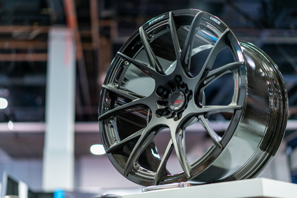 ADV.1 CF .2 Wheels sitting on a pedestal for a car show