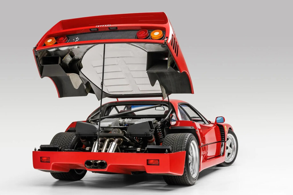 Trunk Hood" with Lexan Glass prooped open, solid white background behind the car