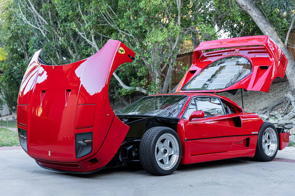 F40 with frunk and rear Engine hood propped open in front of tree branches