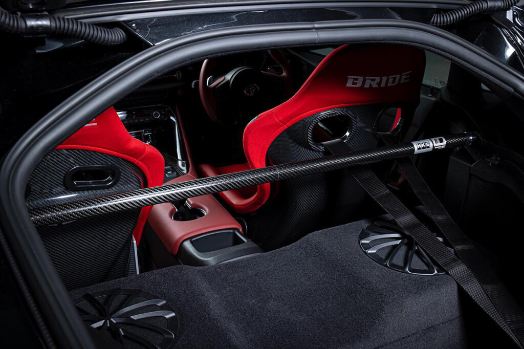 HKS rear cabin strut brace in an A90 Supra with Bride red racing seats
