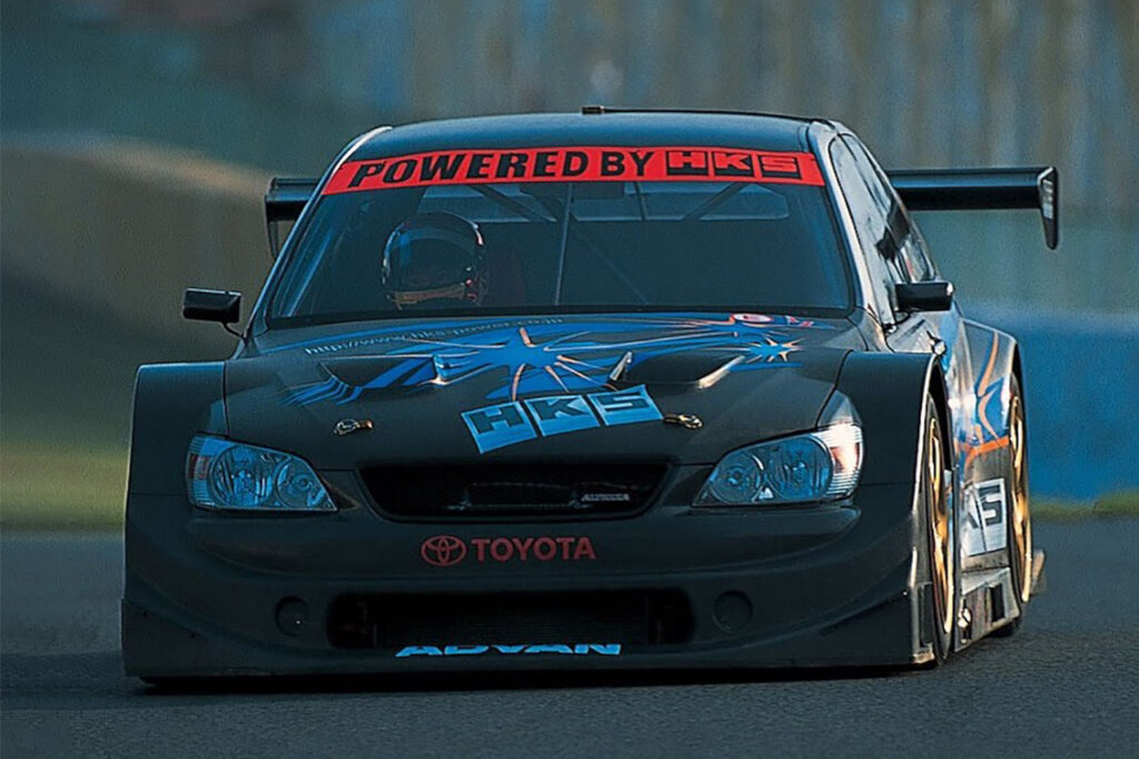 black alteeza HKS with red racing banner on windshield