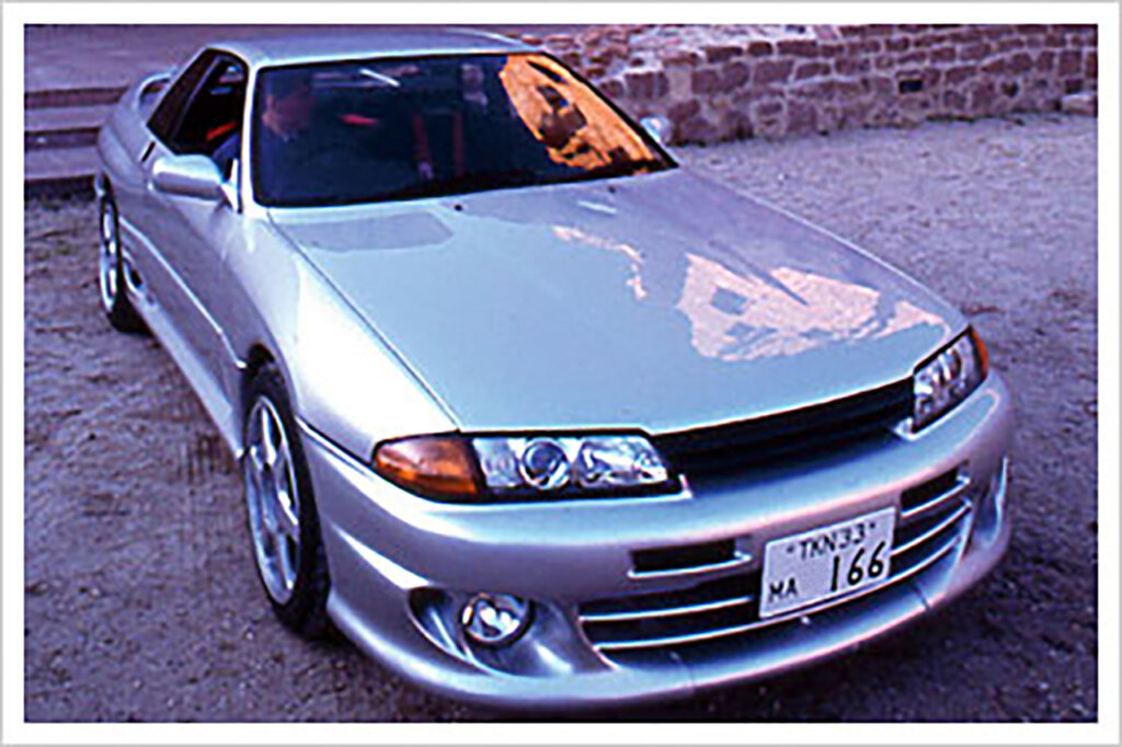 Nissan Skyline Zero-R vehicle parked with brick wall behind it