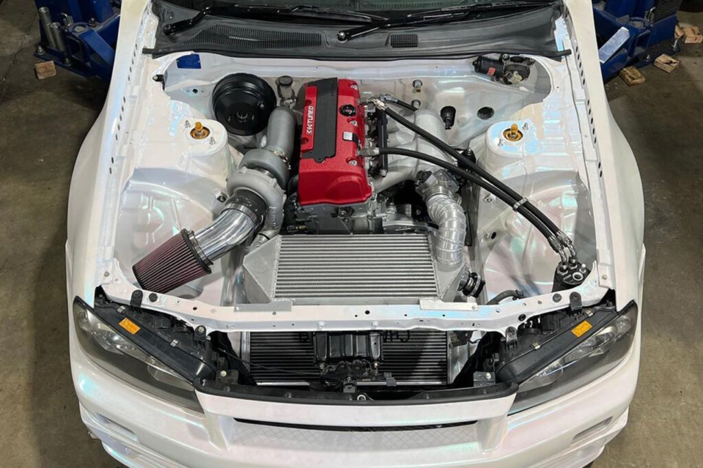 white Nissan Skyline R34 with a K20 engine swap