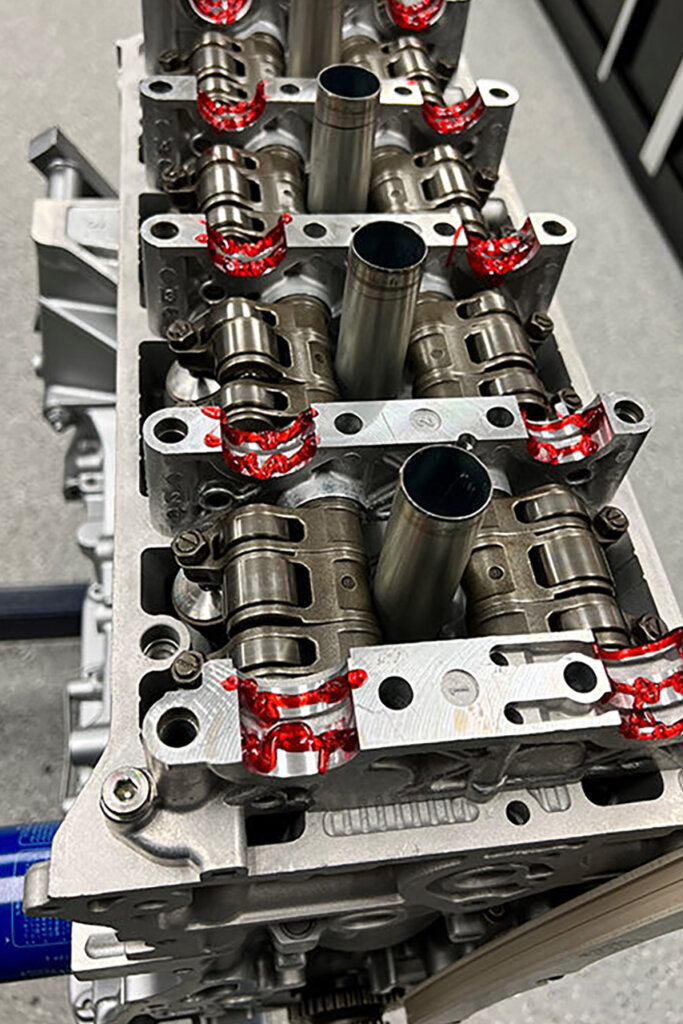 Crankcase open, shafts and pistons red engine lube in certain areas