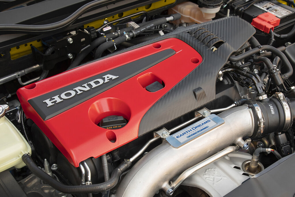 red valve cover with metal tubing and a plate that says Earth Dreams Technology VTEC Turbo