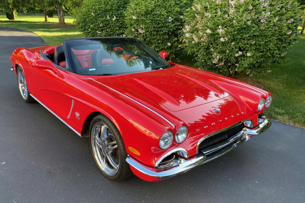 red c1 inspired c5 conversion in front of a green bush