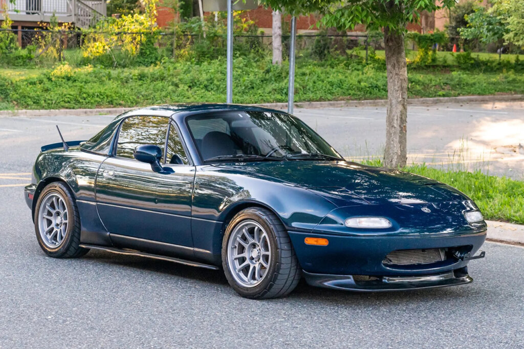 Green Miata parked on a street