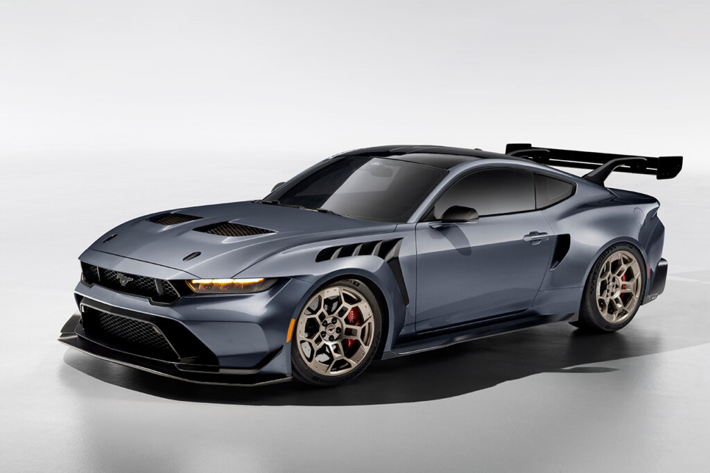 2025 Grey Mustang GTD with a big racing spoiler wing and gold wheels on white background