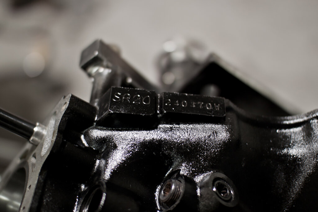 detail shot of engine block code on greasy crankcase