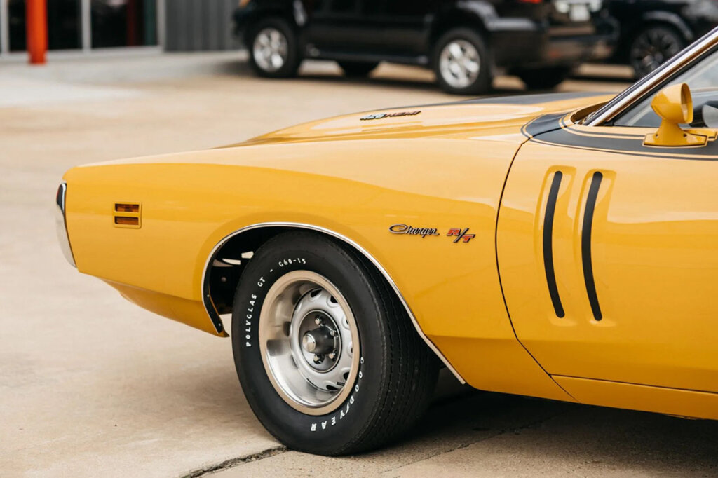 side shot of yellow dodge car parked on street