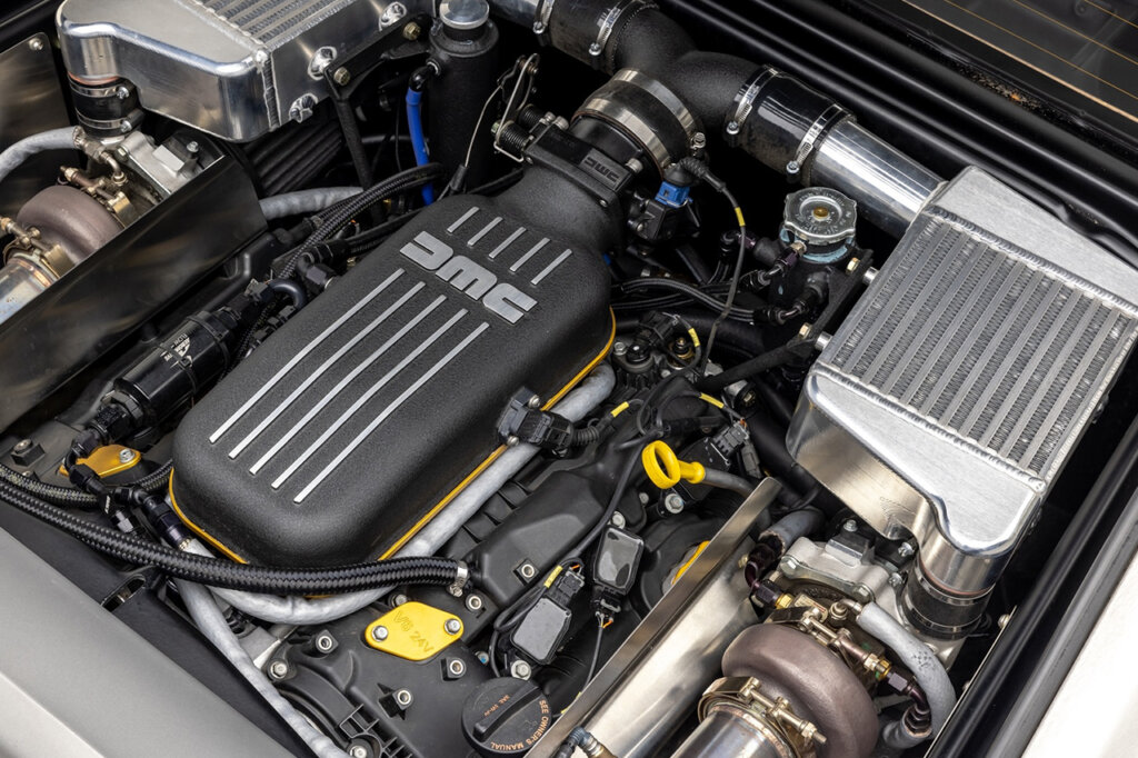 Engine with valve cover that says DMC with striped lines going down from top to bottom