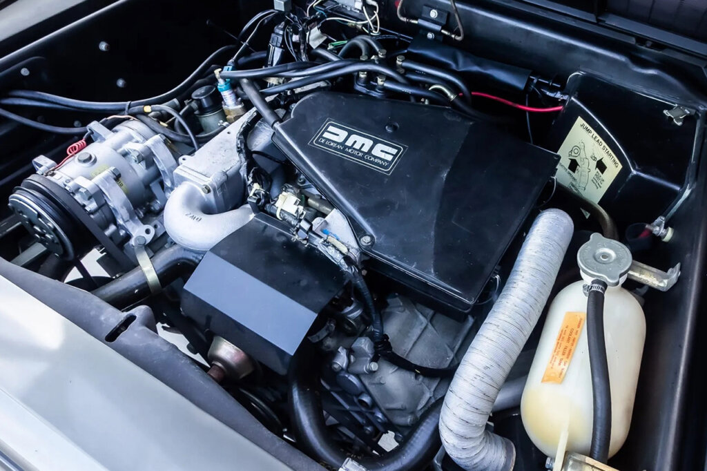 Original v6 engine in a delorean, DMC letters are on the engine