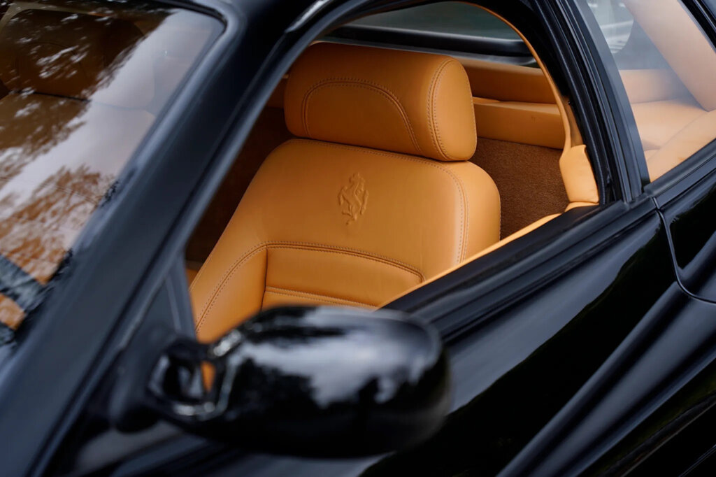 Black Ferrari with Tan leather seats with the Prancing Horse embossed into the seat