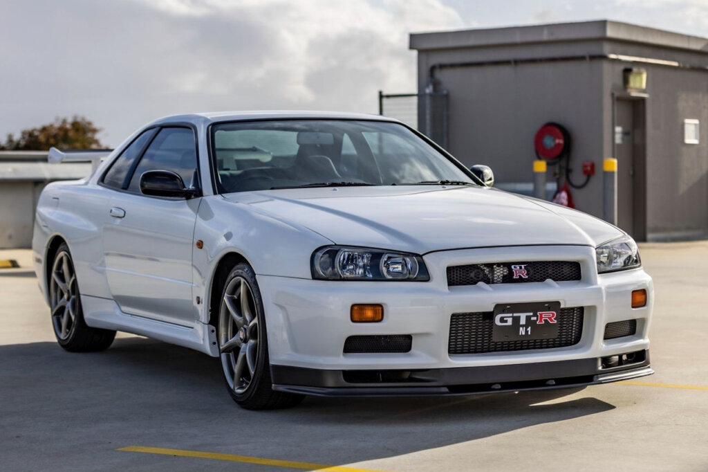 white N1 GTR on a parking garage with cloudy sky