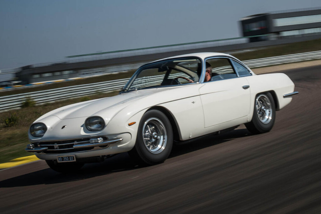 white lambo 250 gt speeding on racetrack
