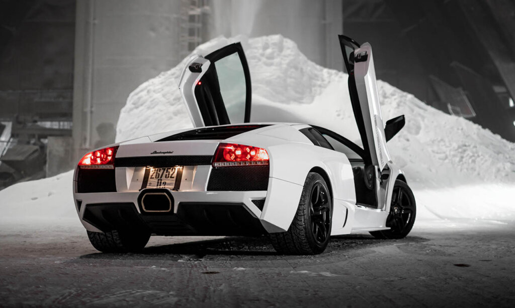 white Murciélago next to a snow bank